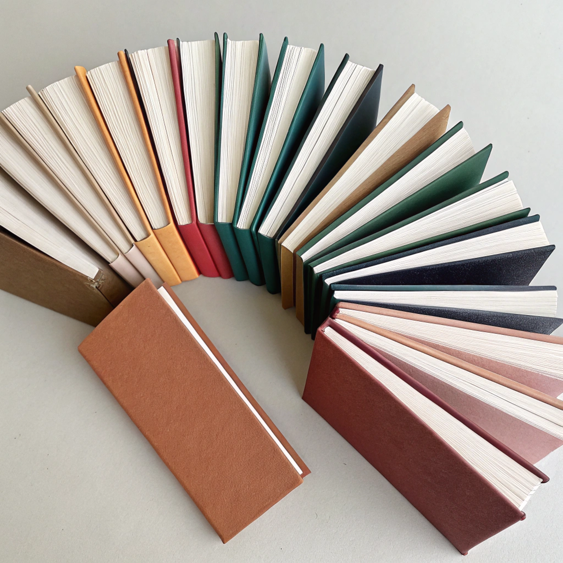 Minimalist scene of thin thesis style books with p