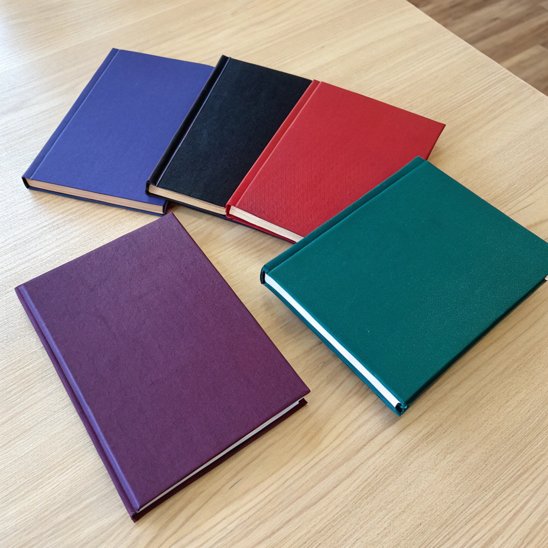 Top view of several thin university thesis books w