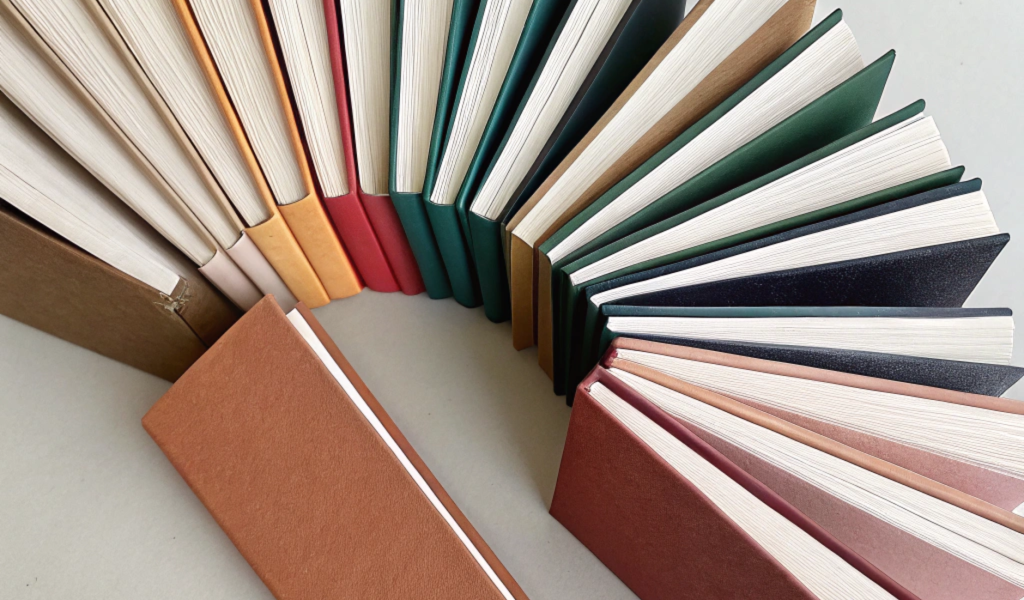 Minimalist scene of thin thesis style books with p