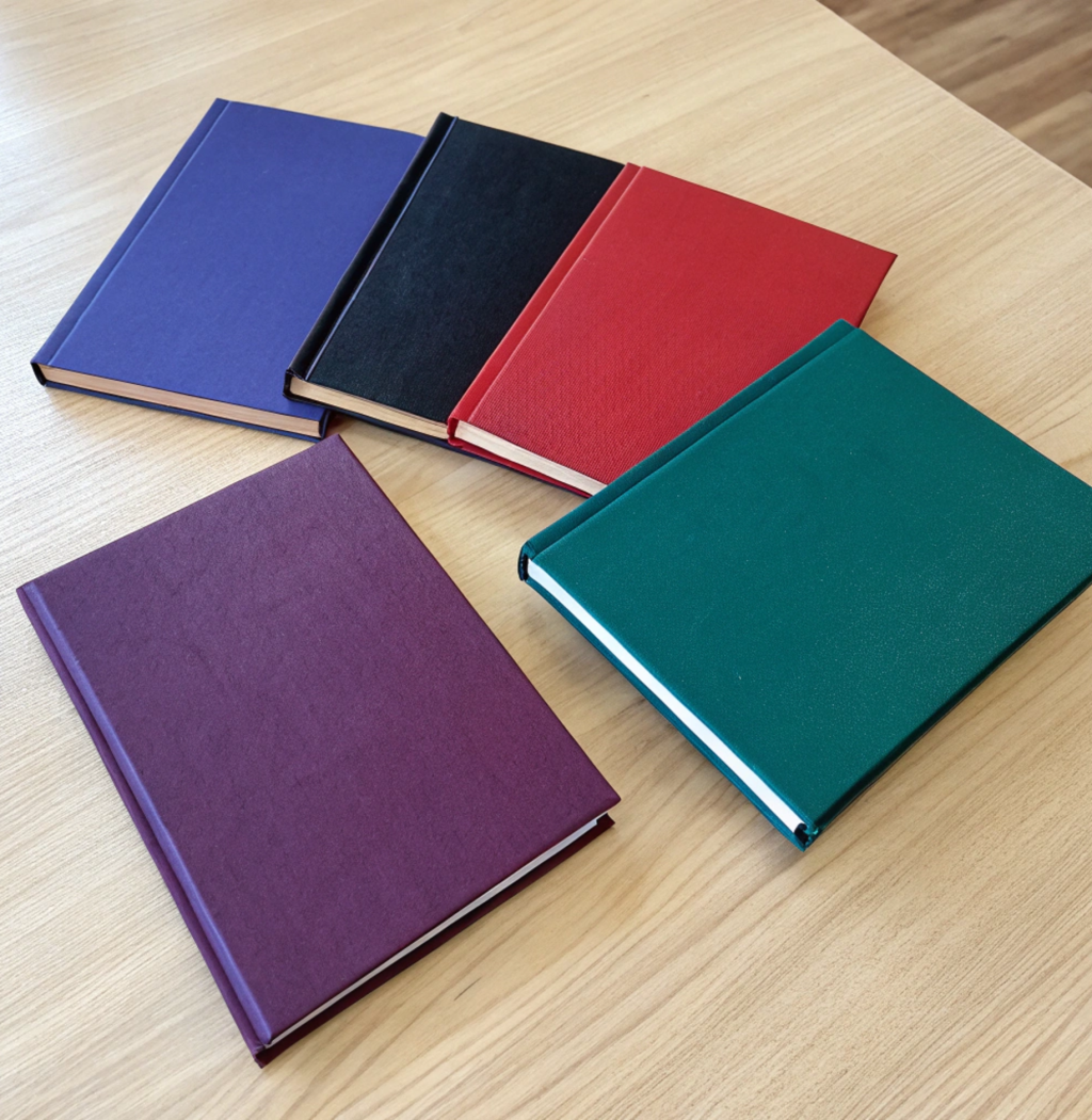 Top view of several thin university thesis books w